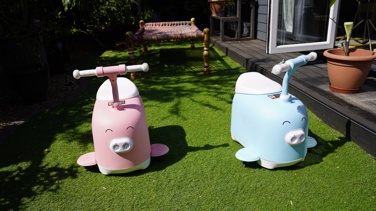 Child enjoying a Piggy Run ride-on outdoors